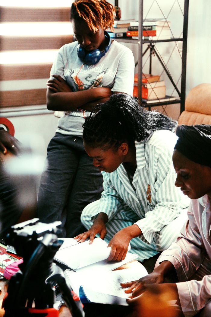 Team gathered around a table for a collaborative study session in Abuja office